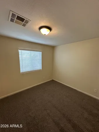an empty room with a empty space and windows