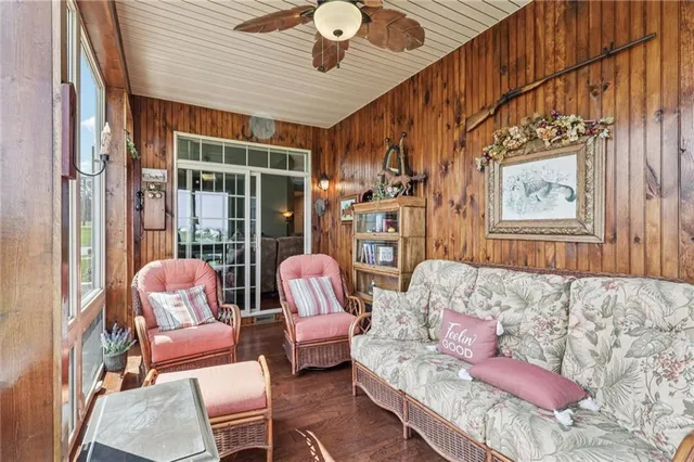 a view of a dining room with furniture a chandelier and wooden floor