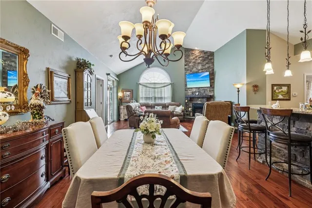 a view of a dining room with furniture wooden floor and chandelier