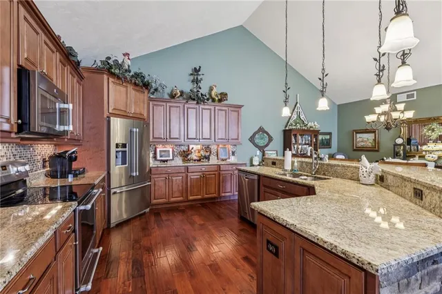 a bedroom with a bed a couch and a large window