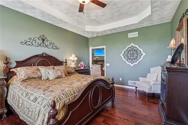 a bedroom with a bed and a chandelier