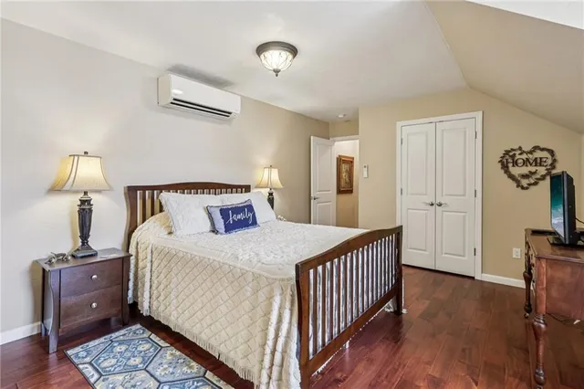 a bedroom with a bed dresser and a window