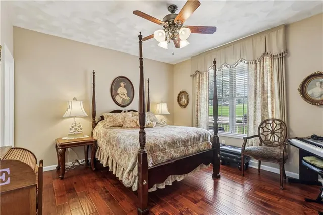 a bedroom with a bed window and a table