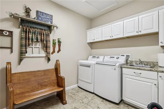 a bathroom with a granite countertop sink a toilet and a window
