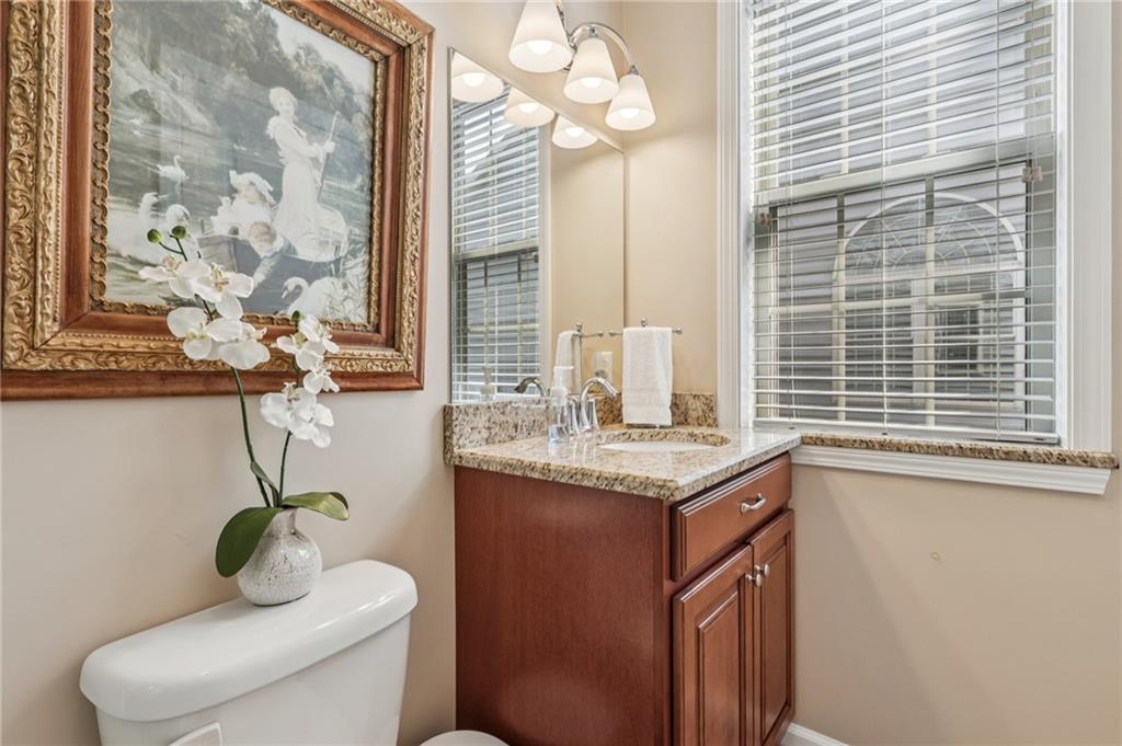 3377 Highway 982 Latrobe, PA 15650 - Photo 39 of 44 a bathroom with a granite countertop sink a toilet and a window