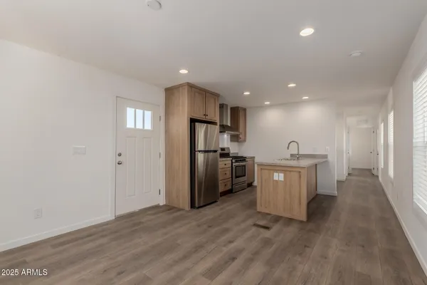 a view of a kitchen with a sink and refrigerator