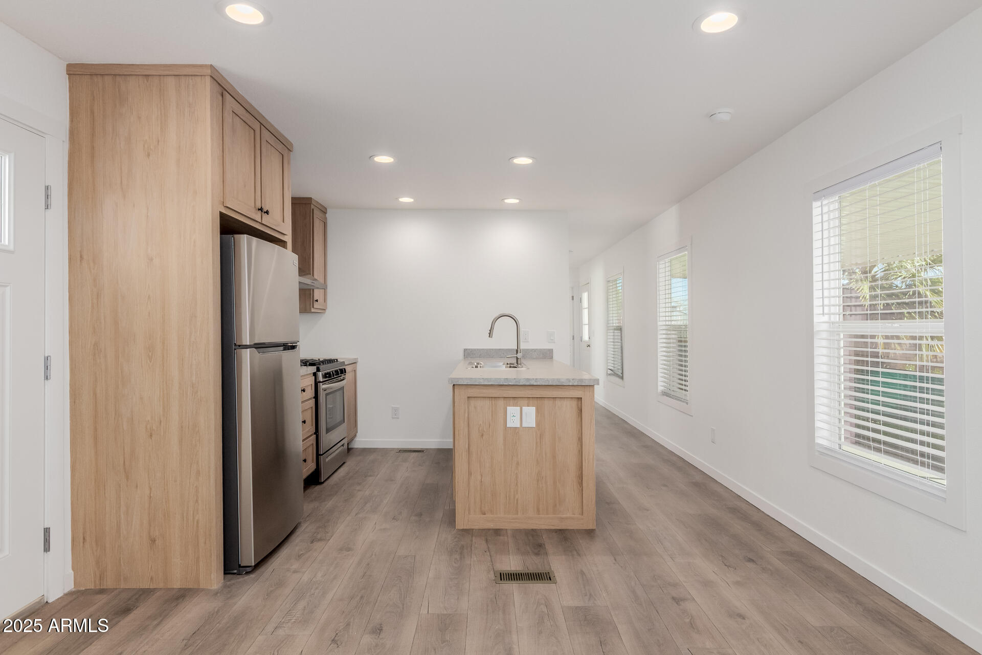 5201 West Camelback Road, Unit F195 Phoenix, AZ 85031 - Photo 5 of 13 a kitchen with stainless steel appliances granite countertop a refrigerator a sink dishwasher and a stove with wooden floor