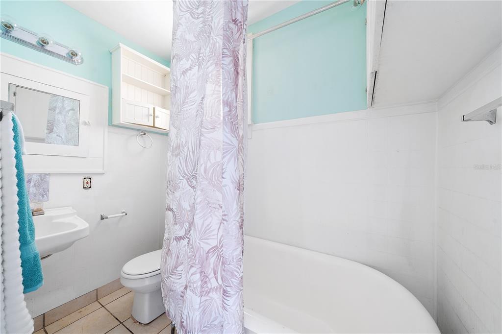 708 Grove Street North St. Petersburg, FL 33701 - Photo 13 of 13 a white toilet sitting next to a shower curtain