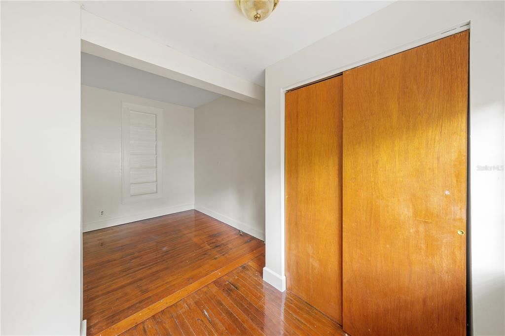 708 Grove Street North St. Petersburg, FL 33701 - Photo 7 of 13 a view of a room with wooden floor and door