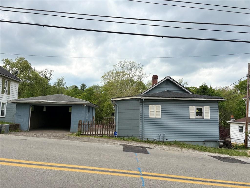 320 Beallsville Road Bentleyville, PA 15314 - Photo 25 of 26 a front view of a house with a garden and garage