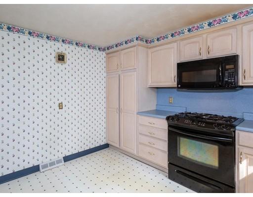67 Newton Road Springfield, MA 01118 - Photo 17 of 41 a kitchen with granite countertop a stove a microwave a sink and cabinets