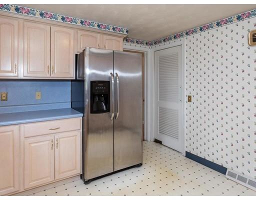 67 Newton Road Springfield, MA 01118 - Photo 18 of 41 a kitchen with stainless steel appliances a refrigerator and cabinets