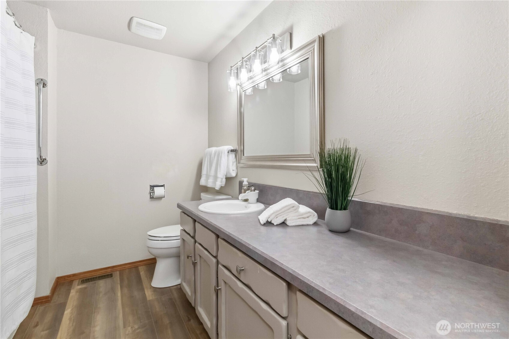 1 Independence Court Longview, WA 98632 - Photo 16 of 30 a bathroom with a granite countertop sink a toilet and mirror