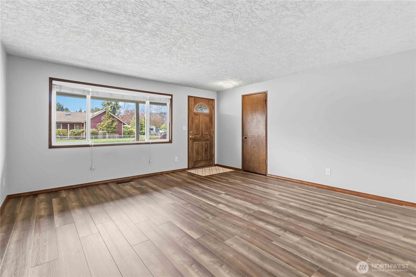 1 Independence Court Longview, WA 98632 - Photo 4 of 30 a view of an empty room with wooden floor and a window