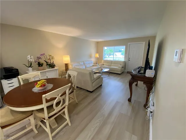 a spacious bedroom with a bed and a lamp