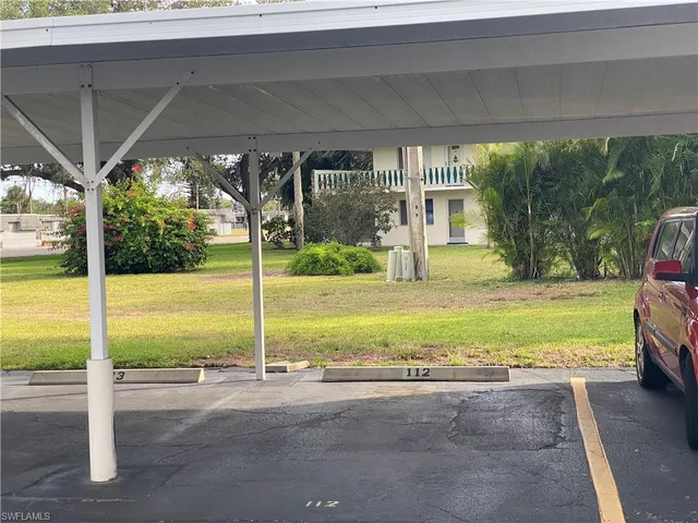 a view of a house with a yard and a sitting area