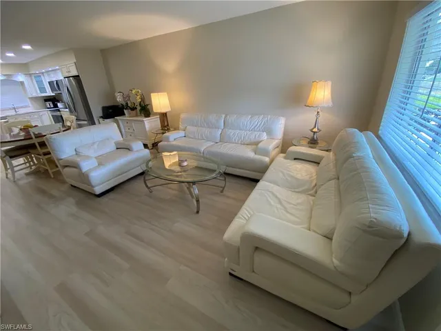 a living room with furniture and a lamp