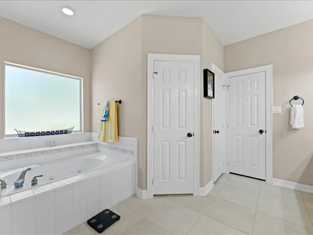 a spacious bathroom with a tub shower and sink