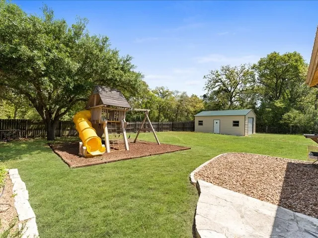 a view of a house with a backyard porch and sitting area