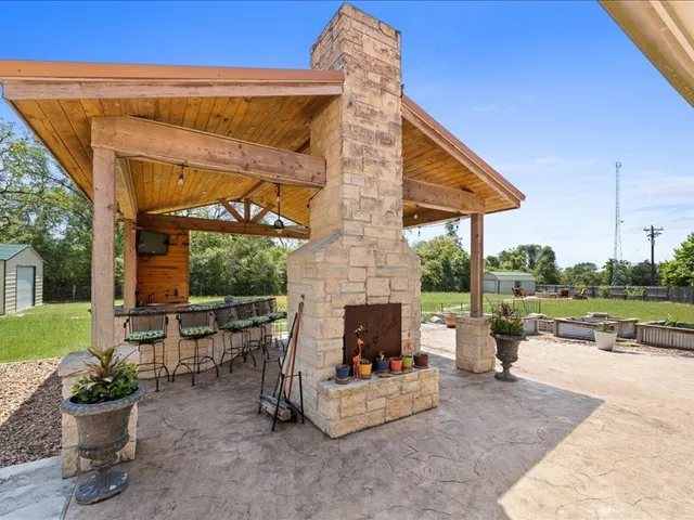 a view of a patio with a table and chairs