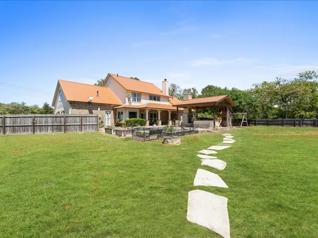 a front view of a house with swimming pool having outdoor seating