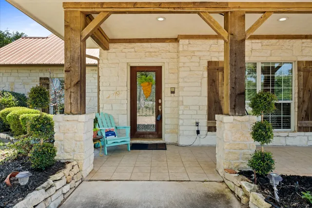 a front view of a house with a garden