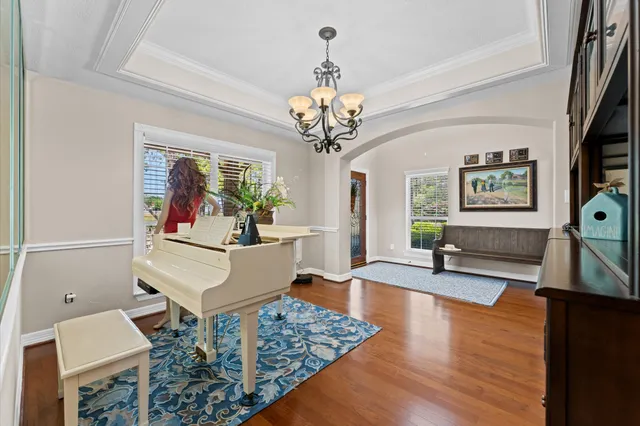a living room with furniture and a chandelier