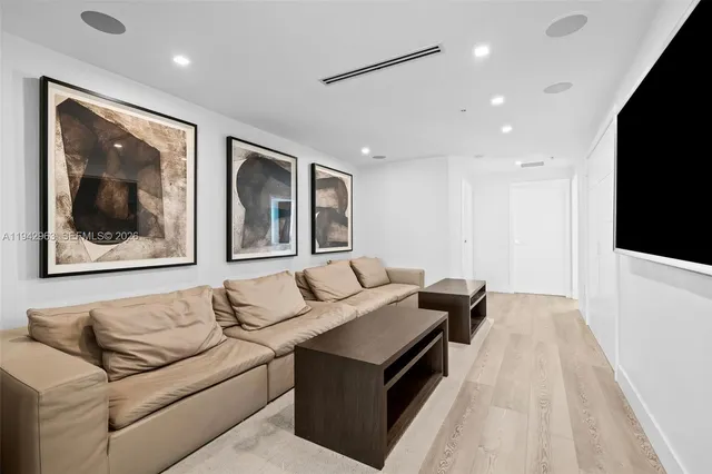 a large bedroom with a bed and a chandelier