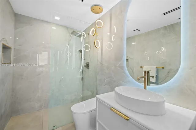 a kitchen with stainless steel appliances granite countertop a stove and a microwave