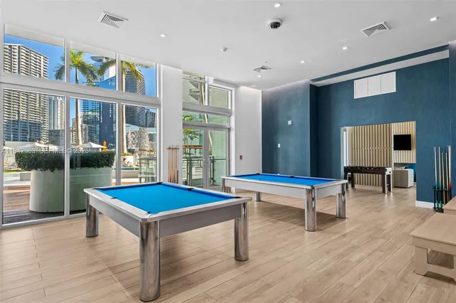 a living room with furniture a flat screen tv and a large window