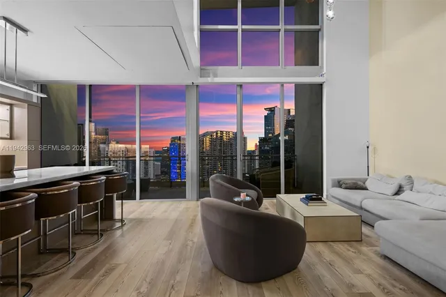 a living room with furniture a rug and white walls