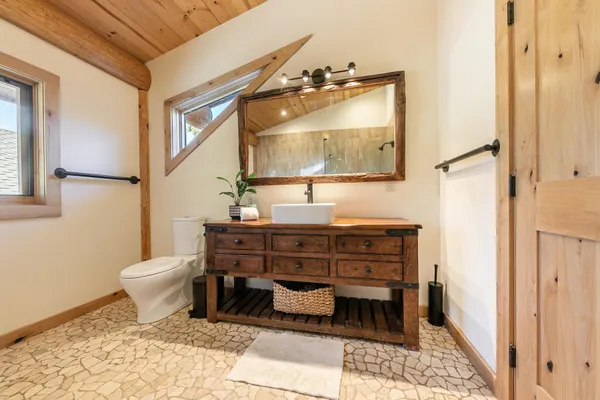 a living room with furniture a chandelier and kitchen view