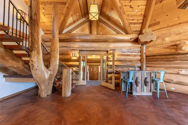 a view of a livingroom with furniture and staircase