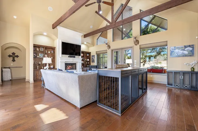 a living room with a flat screen tv and a fireplace