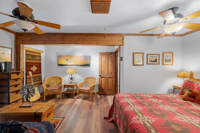 a bedroom with bed and wooden floor