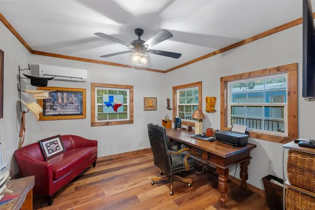 a view of a workspace with furniture window and wooden floor