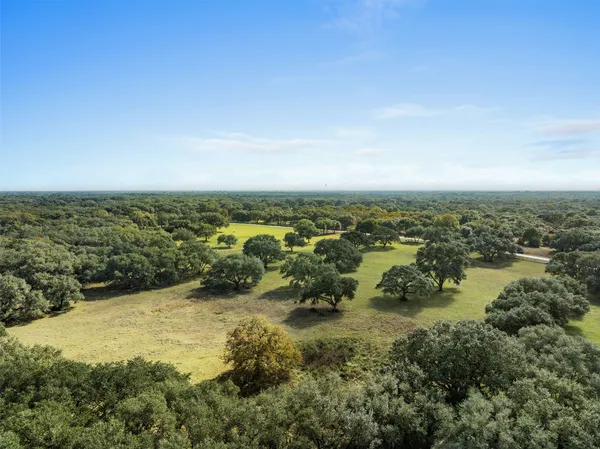 an aerial view of ocean with residential houses with outdoor space