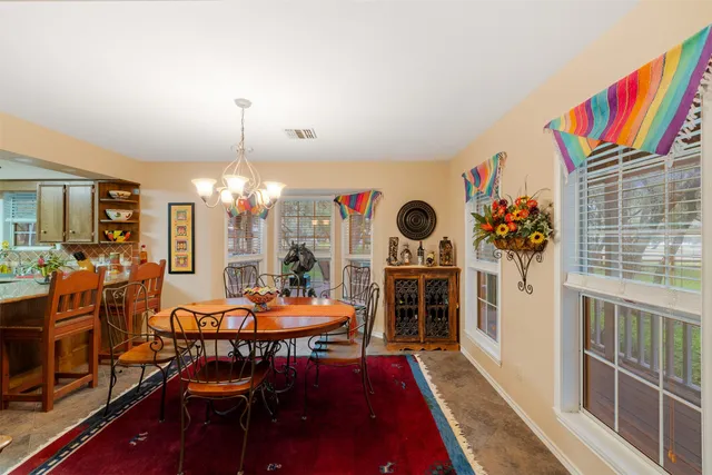 a dining room filled with furniture and window