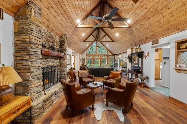 a living room with furniture a fireplace and wooden floor