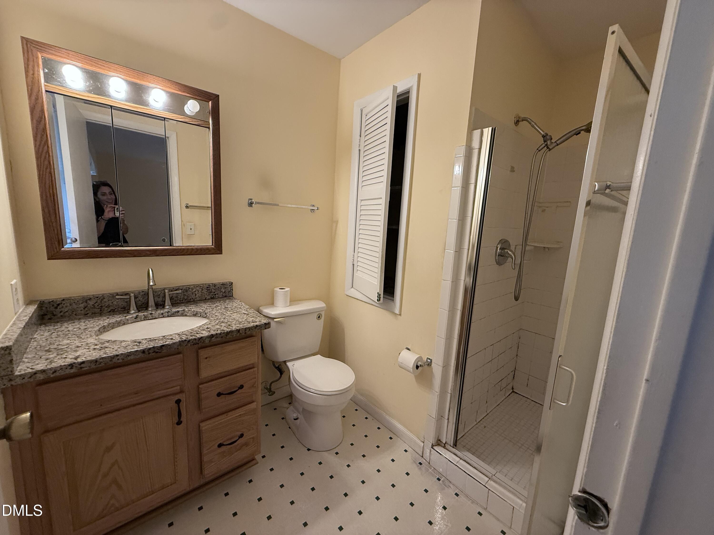 1010 Wyldewood Road Durham, NC 27704 - Photo 12 of 26 a bathroom with a granite countertop sink toilet and shower
