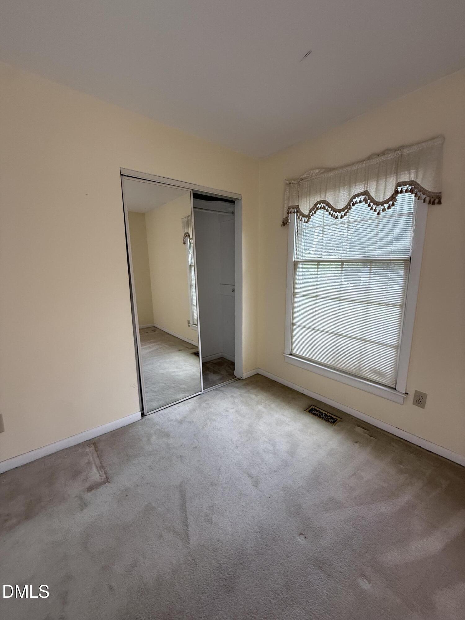 1010 Wyldewood Road Durham, NC 27704 - Photo 19 of 26 an empty room with a fireplace and cabinet