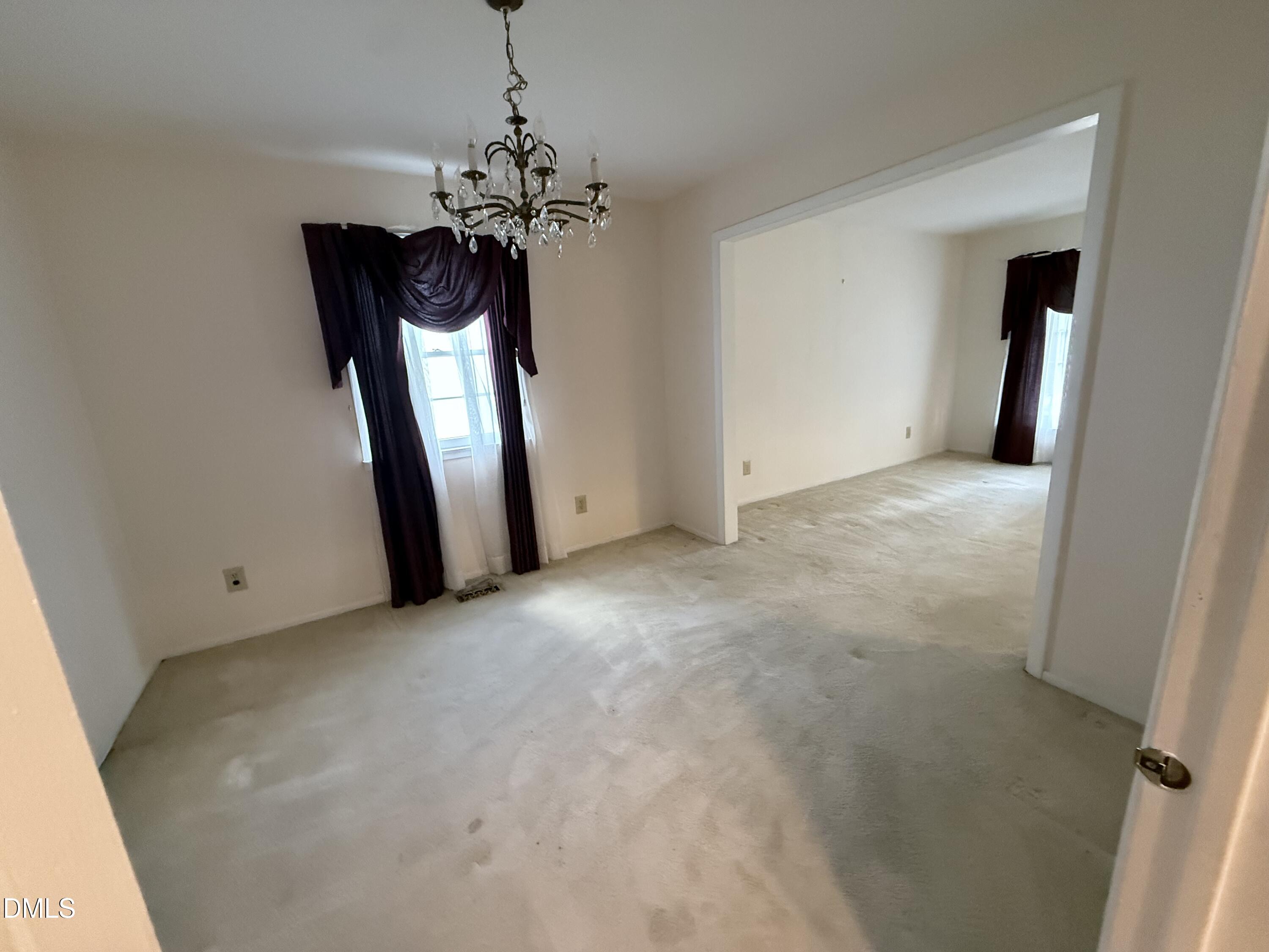 1010 Wyldewood Road Durham, NC 27704 - Photo 7 of 26 a view of a chandelier in big room and chandelier