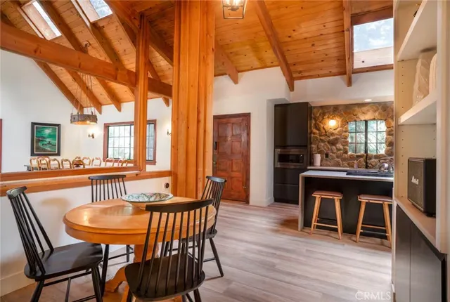 a dining room with furniture and wooden floor