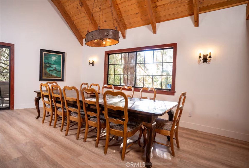 764 Fern Road Lake Arrowhead, CA 92385 - Photo 15 of 60 a view of a dining room with furniture and wooden floor