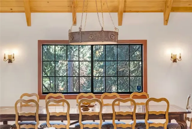 a living room with furniture a wooden floor and a chandelier