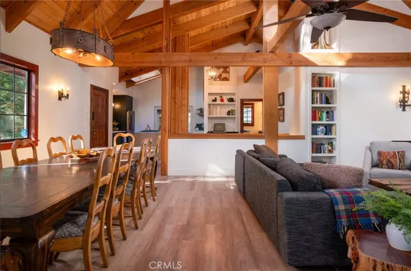 a living room with furniture a fireplace and a floor to ceiling window