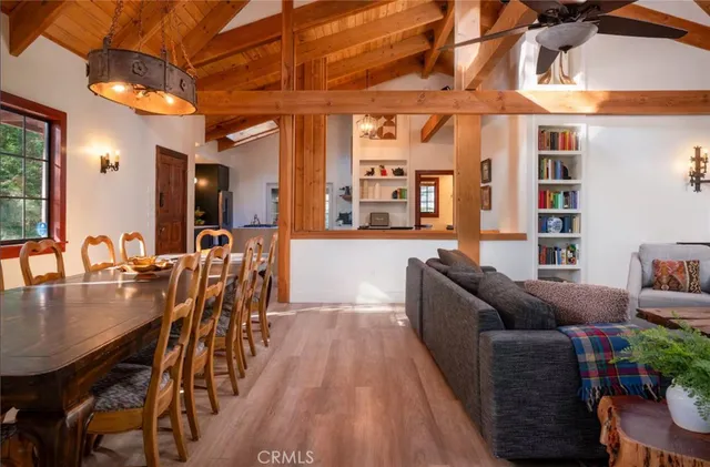 a living room with furniture a fireplace and a floor to ceiling window