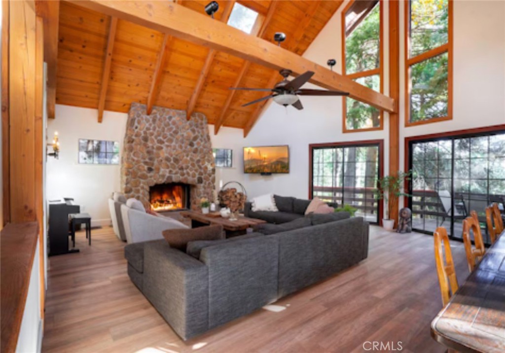 764 Fern Road Lake Arrowhead, CA 92385 - Photo 18 of 60 a living room with furniture a fireplace and a floor to ceiling window