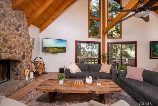 a dining room with furniture a chandelier and a large window