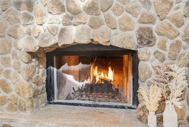 a large bedroom with bed and wooden floor